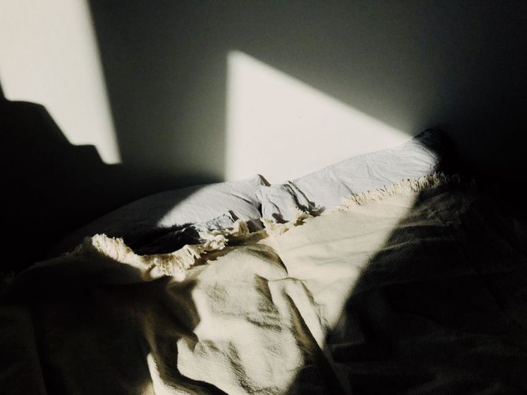 A calm, tidy bedroom in soft evening light